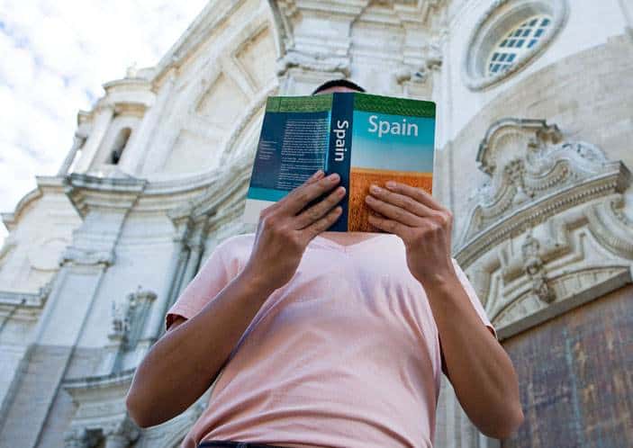 Tourist-in-Spain-with-guidebook